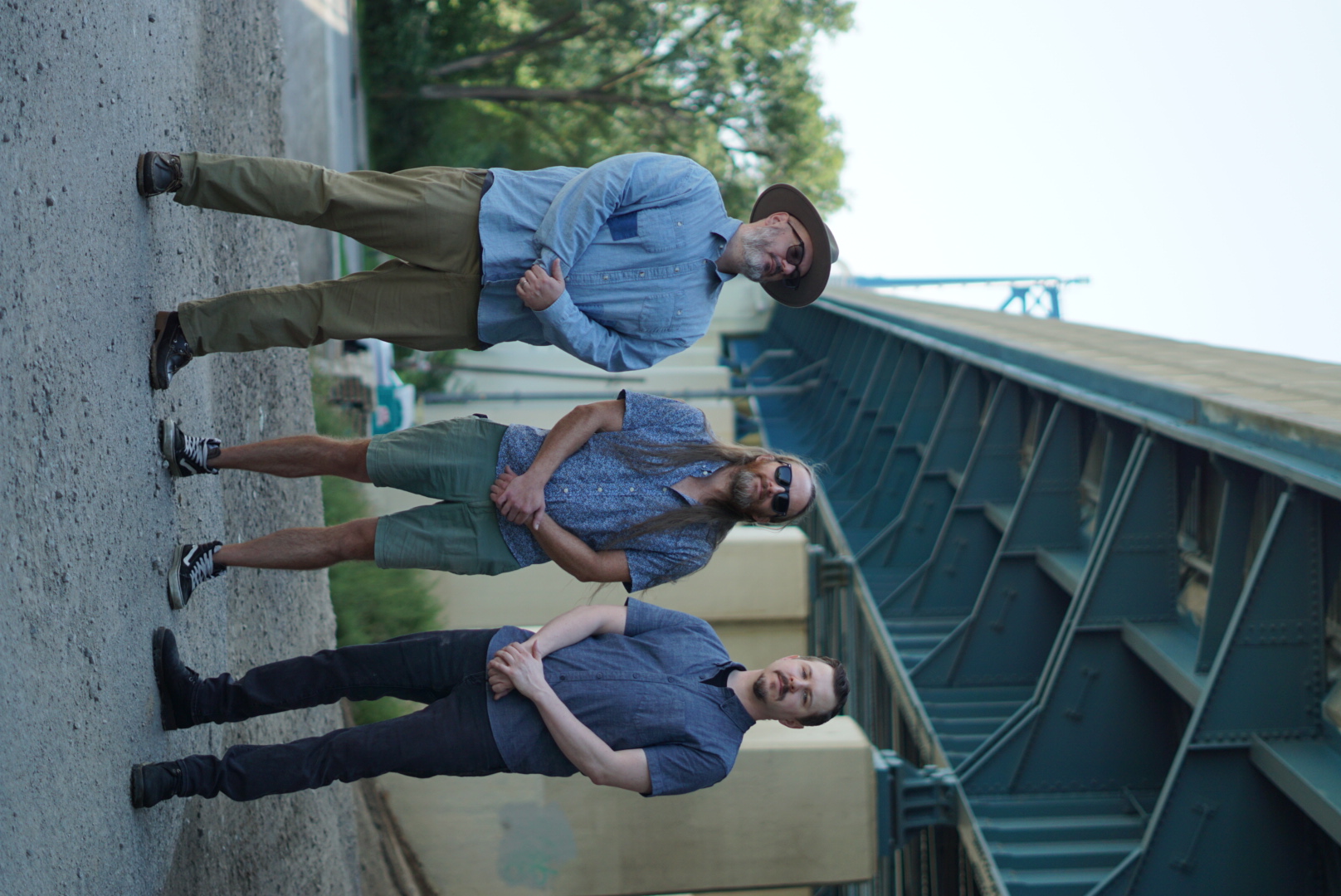 Andrew, Matt, and Chris of Tonewheels standing under a bridge in Toledo